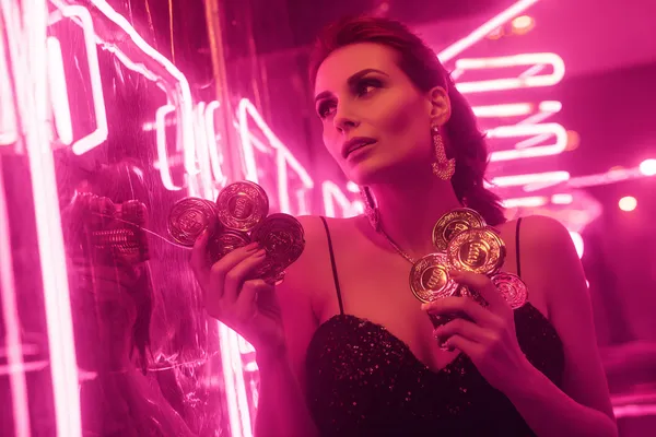 A glamorous woman holding casino chips in a neon-lit environment, representing the premium online casino atmosphere of BDOK.