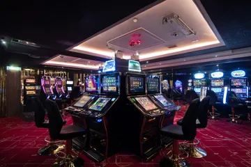 A close-up shot of golden coins falling around a spinning roulette wheel, representing immersive casino action at BDOK.