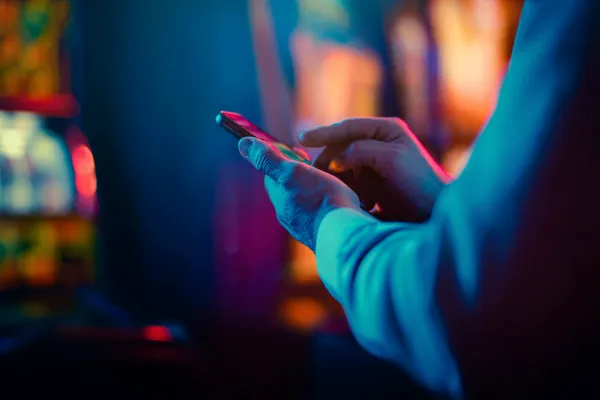 BDOK — A high-class gaming experience without limits A woman in a luxurious green gown next to an ornate roulette wheel, capturing the upscale casino mood of BDOK.